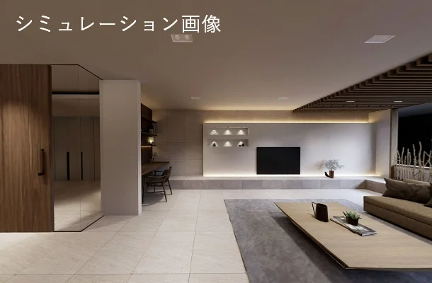 Modern open-plan living room with a beige sofa, low wooden coffee table on a gray rug, wall-mounted TV, and built-in shelves with warm recessed lighting.